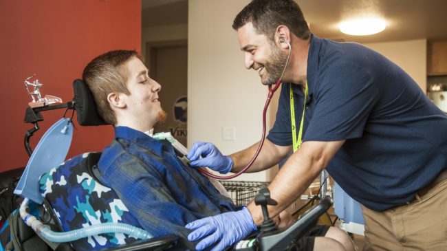 PHS patient Jordan receives care from his respiratory therapist Robi