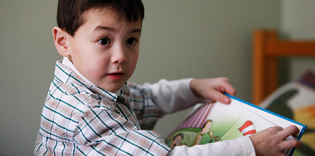 PHS patient Tyler reads a book at home